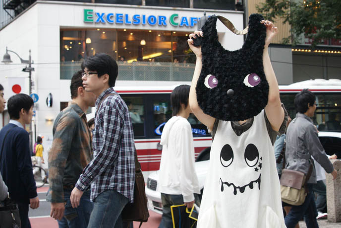 Excelsior Caffe in Shibuya, Tokyo Japan. Coffee shop with soy lattes. Bunny as head, purse on girl with funny cute Japanese street fashion dress.