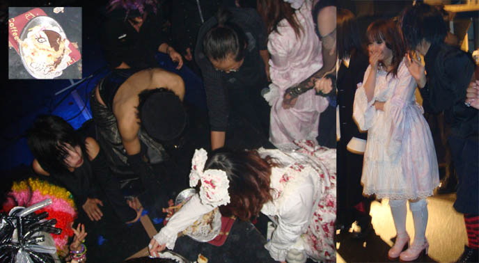 Goth vampire feeding frenzy on cake at Alamode Goth Loli Heaven club night in Tokyo Japan. Wild birthday party for DJ Chihiro. Sweet Lolitas at nightclub.