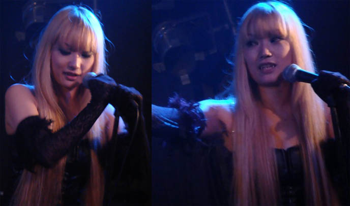 Aural Vampire blonde electro singer performing live at Tokyo Dark Castle. Cute Japanese singer in band singing into microphone, dancing.