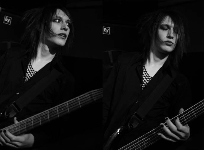 Classic black and white 1970s rockstar concert photography, glam rock androgyny musician, long emo hair and eye makeup on boy.