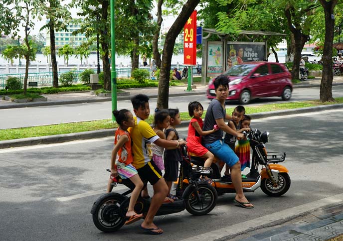 vietnamese children balancing on motorcycle