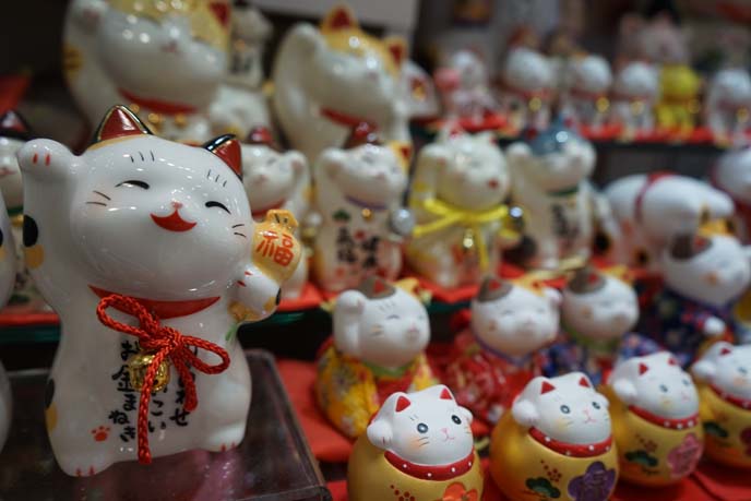 fortune cat statues, both paws raised