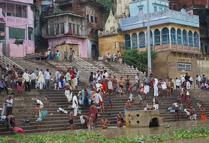 men bathing in river ganges