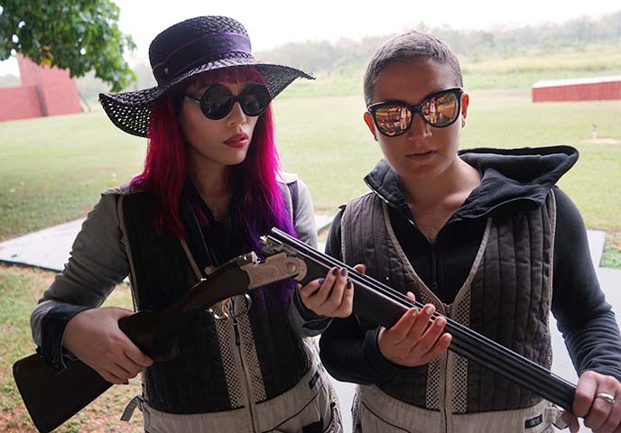 girls posing with shotgun