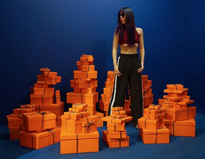 pile of hermes orange boxes musee du bonbon