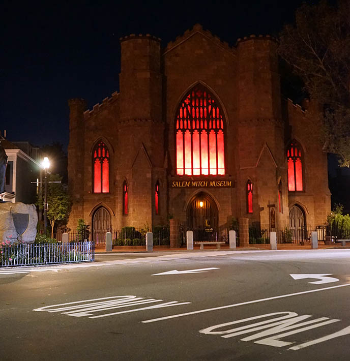 salem witch museum church building glowing red night