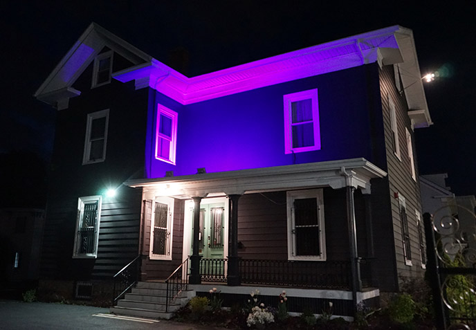 the satanic temple headquarters salem at night purple glowing lights