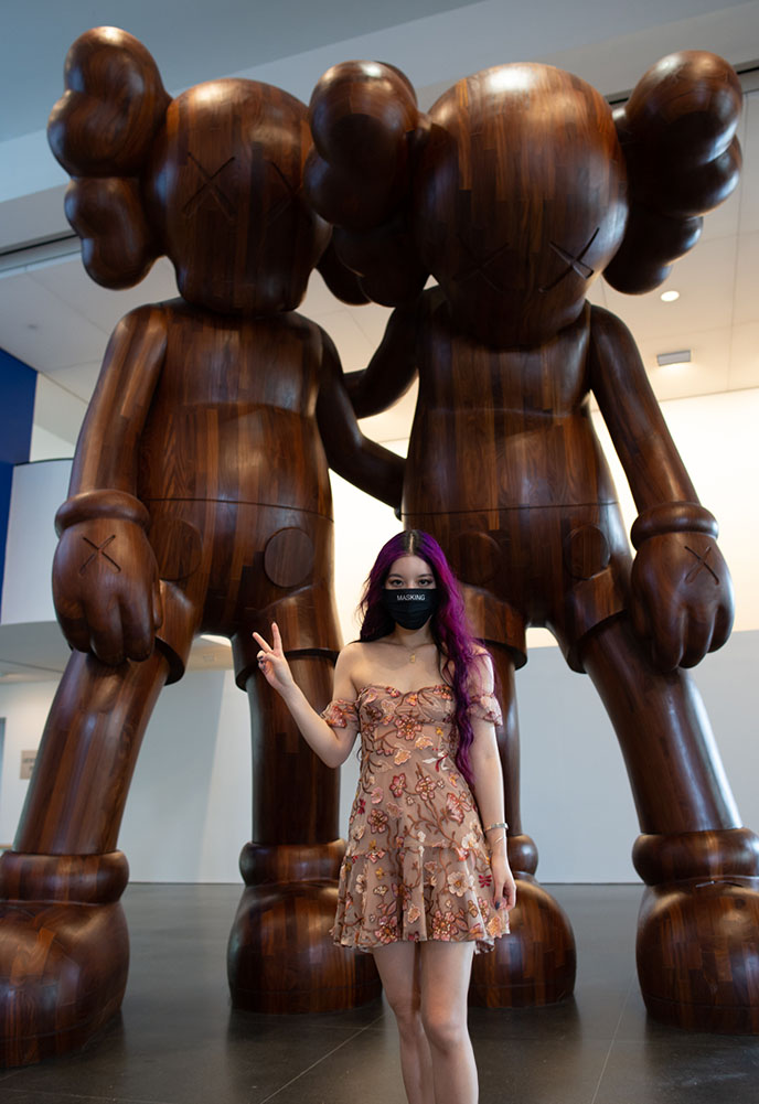 kaws two wooden companions friends arm in arm