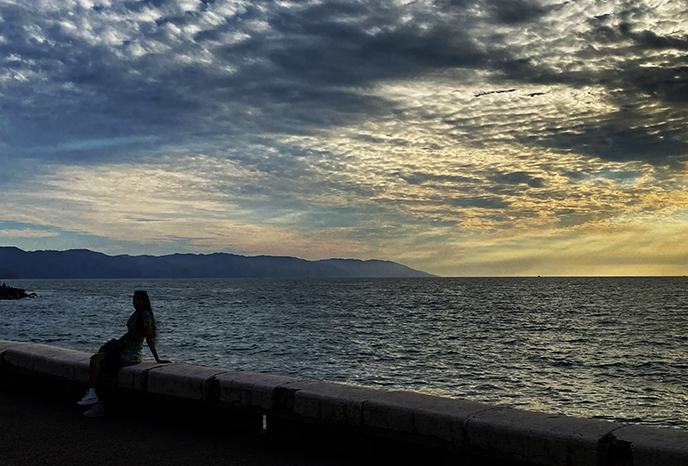 girl silhouette beach at night malecon mexico 